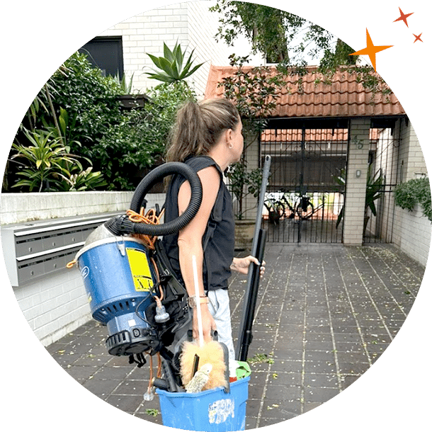 Maidforyou cleaner Gabby holding vacuum outside a clients home